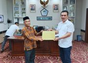 Plt Sekretaris Daerah Aceh Utara, Jamaluddin, saat menyerahkan SK PPPK Paruh Waktu secara simbolis kepada perwakilan K3S dan Sub Rayon SMP di Aceh Utara